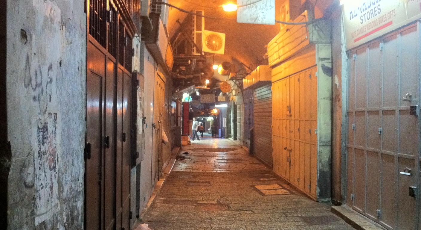 Pedestrians moving through Suk Khan Az-Zait in Jerusalem's Old City
