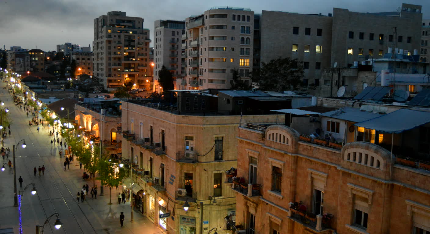 Evening view down Jaffa Road in Jerusalem with pedestrians and tram tracks
